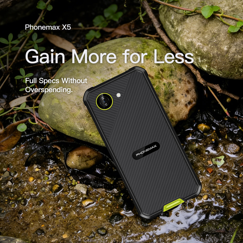 Black Phonemax X5 smartphone resting on wet rocks beside green foliage
